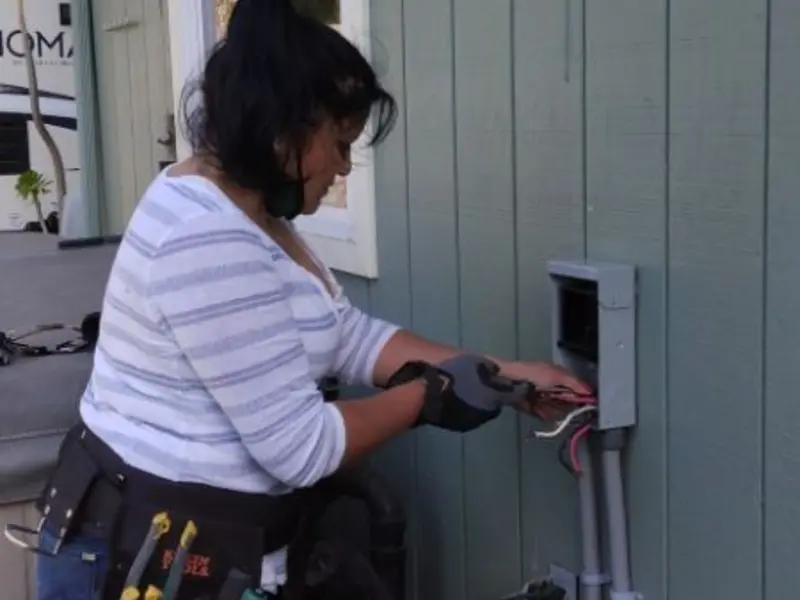 Licensed electrician wiring an exterior subpanel in Paloma Creek